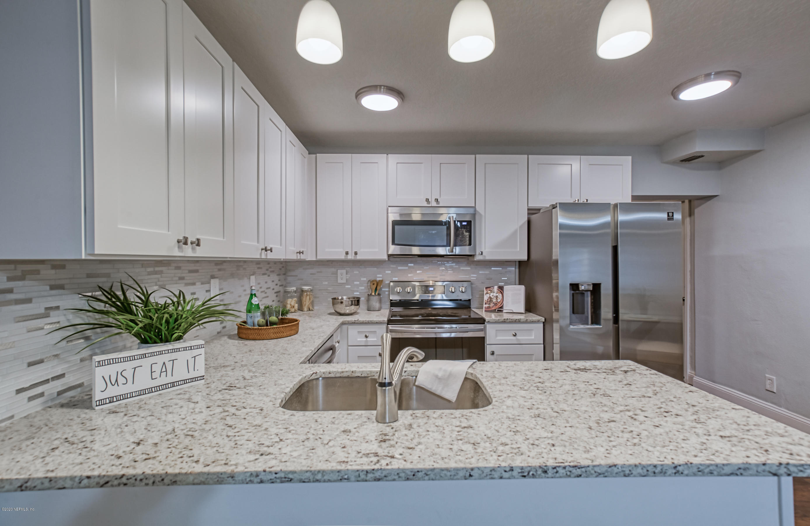 6711 Ryance Road Jacksonville, FL 32211 - Photo 8 of 26 a kitchen with granite countertop a sink a stove and refrigerator