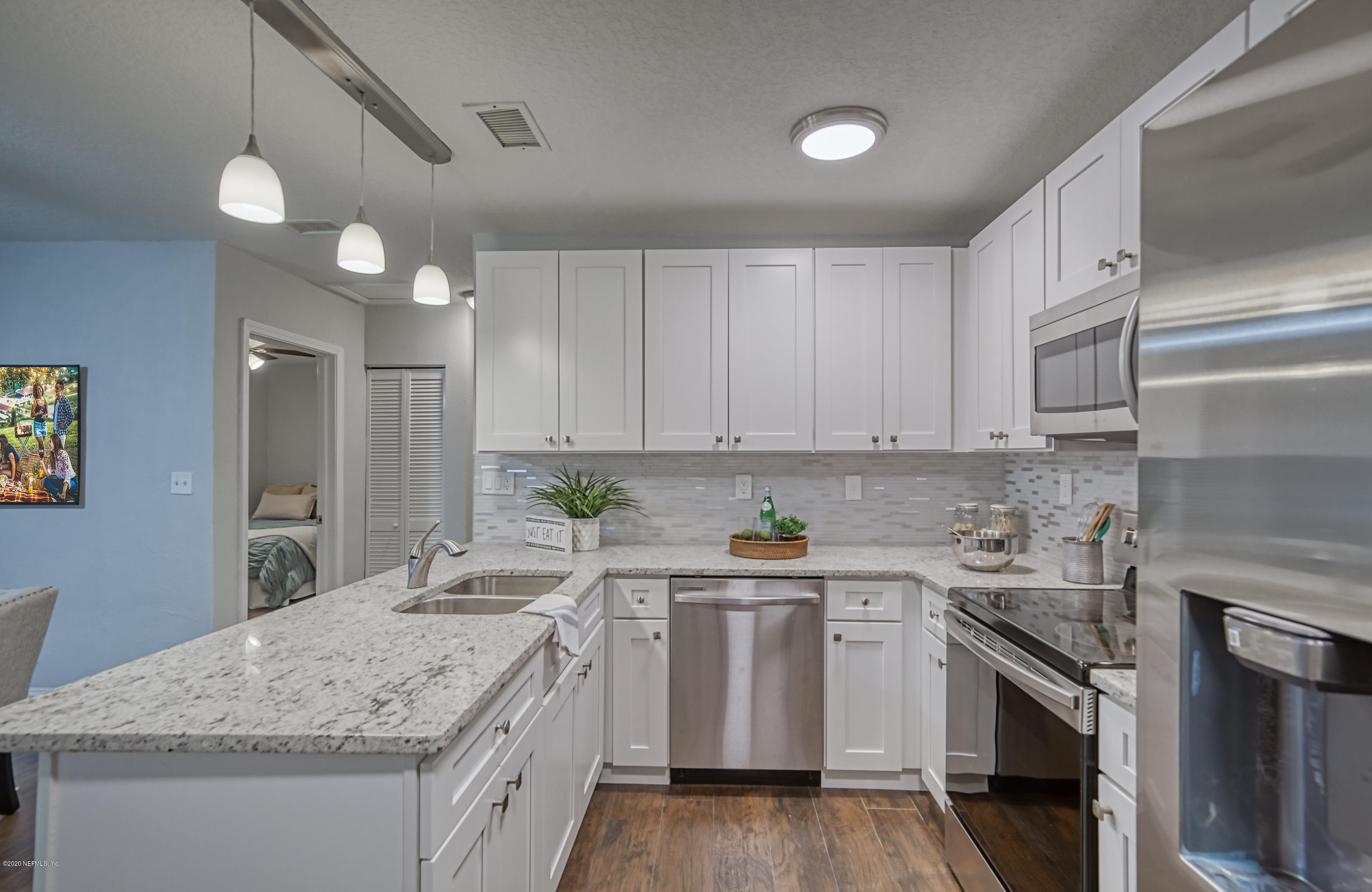 6711 Ryance Road Jacksonville, FL 32211 - Photo 10 of 26 a kitchen with granite countertop a sink stainless steel appliances and cabinets