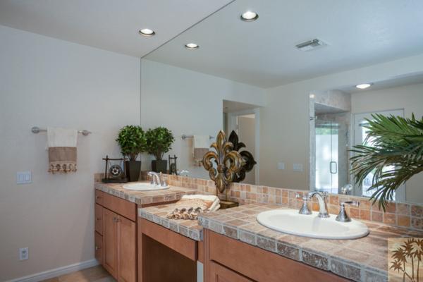 2 Boothill Circle Rancho Mirage, CA 92270 - Photo 14 of 42 a bathroom with a granite countertop sink a mirror and a vanity