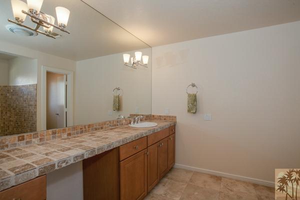 2 Boothill Circle Rancho Mirage, CA 92270 - Photo 17 of 42 a bathroom with a granite countertop sink a mirror and shower view
