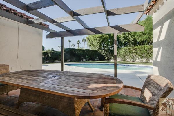 2 Boothill Circle Rancho Mirage, CA 92270 - Photo 22 of 42 a view of a patio with a table and chairs under an umbrella