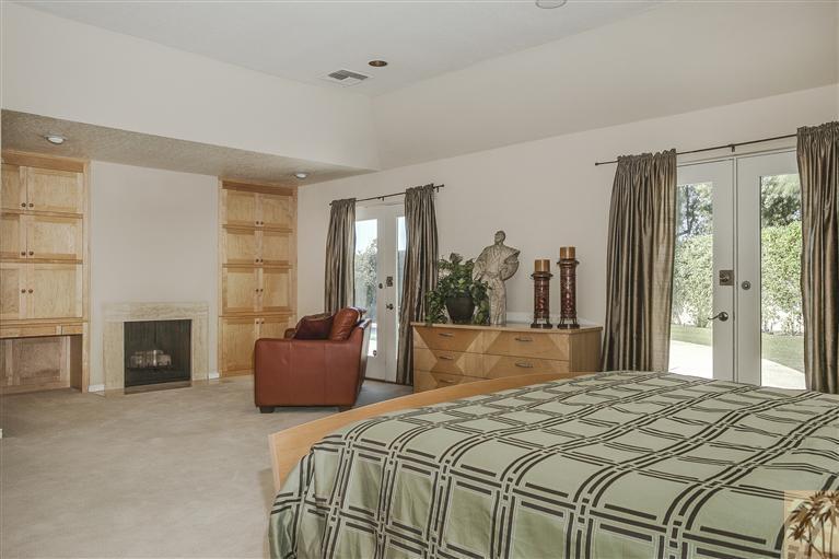 2 Boothill Circle Rancho Mirage, CA 92270 - Photo 29 of 42 a bedroom with a bed and a fireplace