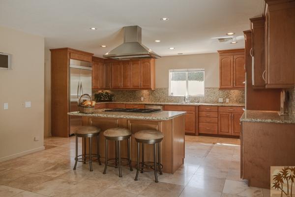 2 Boothill Circle Rancho Mirage, CA 92270 - Photo 8 of 42 a kitchen with kitchen island granite countertop wooden cabinets and white stainless steel appliances