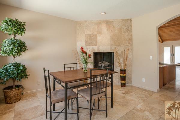 2 Boothill Circle Rancho Mirage, CA 92270 - Photo 9 of 42 a living room with furniture a potted plant and a fireplace