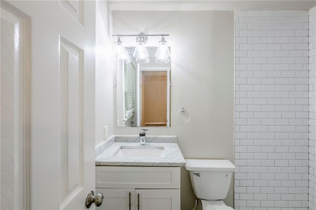 3735 Boulder Park Drive Southwest Atlanta, GA 30331 - Photo 11 of 29 a bathroom with a toilet sink and mirror