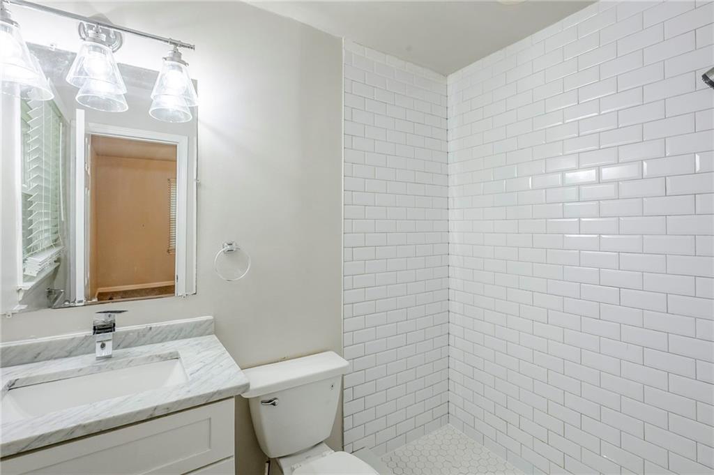 3735 Boulder Park Drive Southwest Atlanta, GA 30331 - Photo 12 of 29 a bathroom with a toilet a sink and mirror