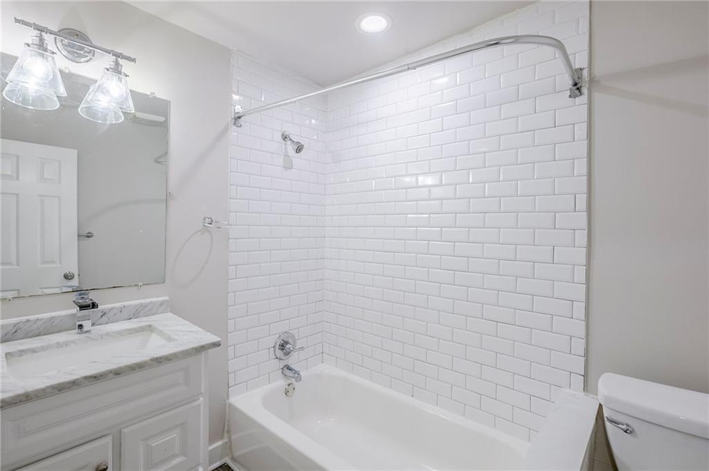 3735 Boulder Park Drive Southwest Atlanta, GA 30331 - Photo 19 of 29 a bathroom with a granite countertop sink a toilet and shower