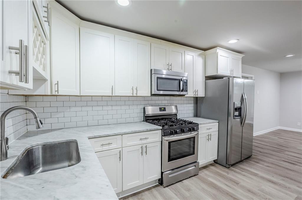 3735 Boulder Park Drive Southwest Atlanta, GA 30331 - Photo 5 of 29 a kitchen with stainless steel appliances a stove sink and microwave