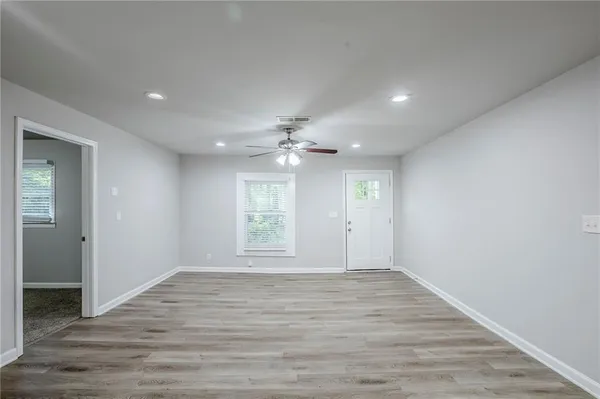 wooden floor in an empty room with a window