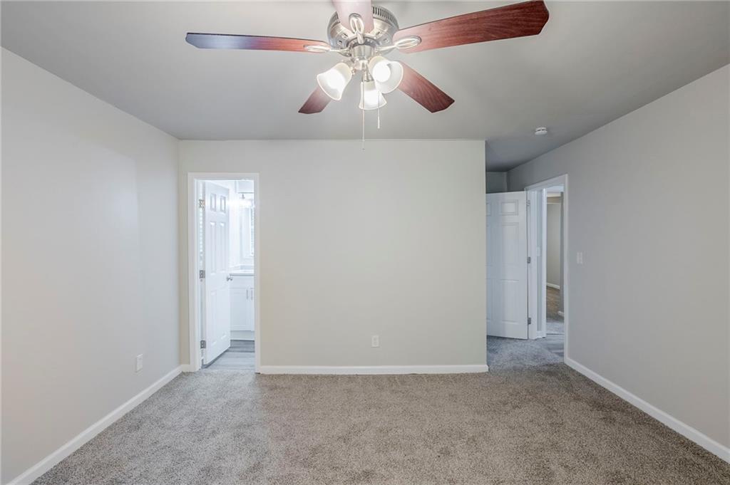 3735 Boulder Park Drive Southwest Atlanta, GA 30331 - Photo 9 of 29 an empty room with closet and a chandelier fan