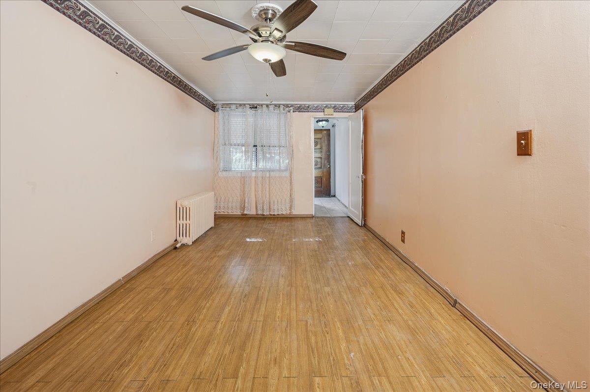 412 Calhoun Avenue Bronx, NY 10465 - Photo 18 of 26 a view of empty room with wooden floor