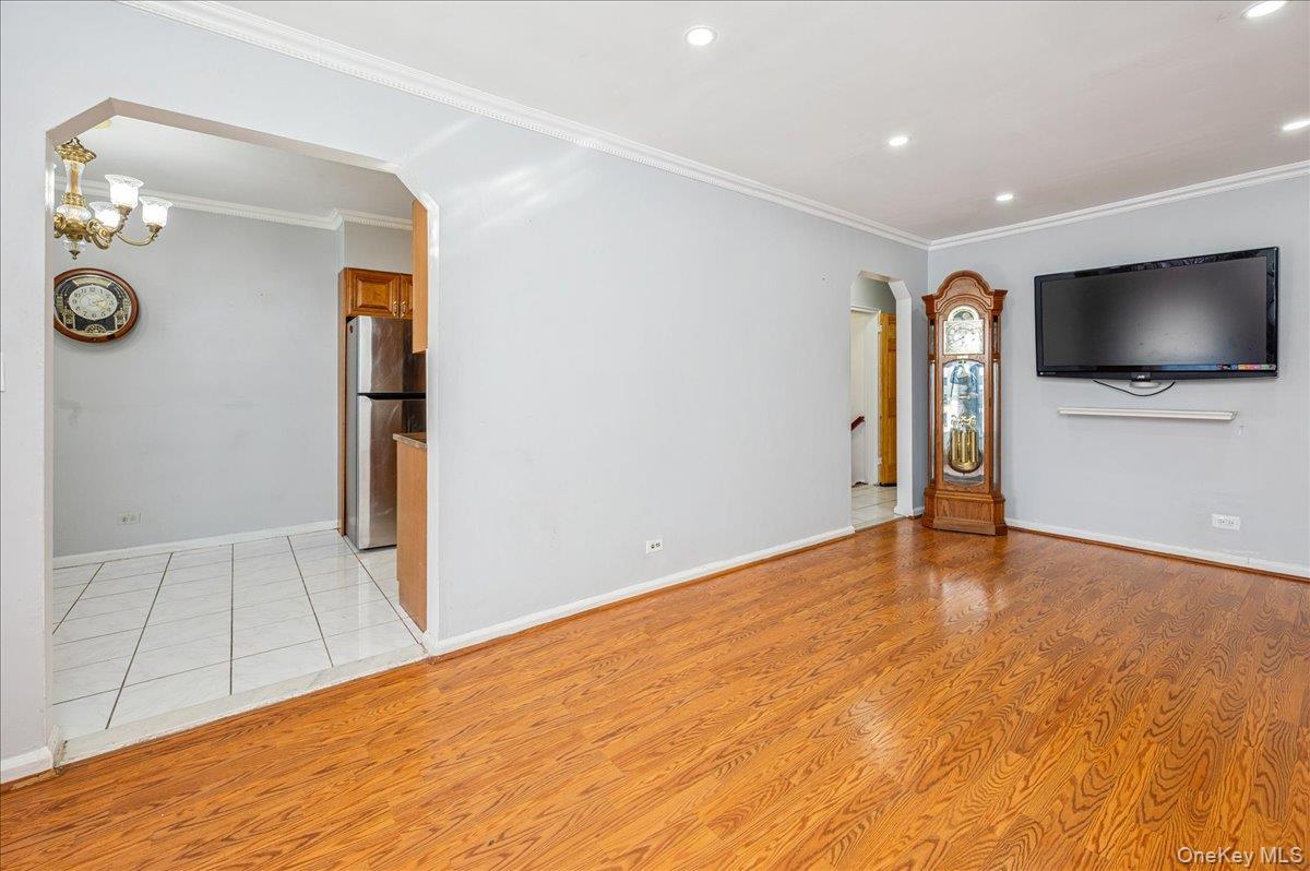 412 Calhoun Avenue Bronx, NY 10465 - Photo 6 of 26 a view of a livingroom with wooden floor and a flat screen tv