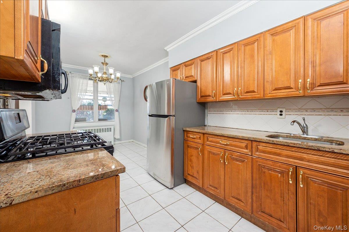 412 Calhoun Avenue Bronx, NY 10465 - Photo 7 of 26 a kitchen with stainless steel appliances granite countertop a stove a sink and a refrigerator