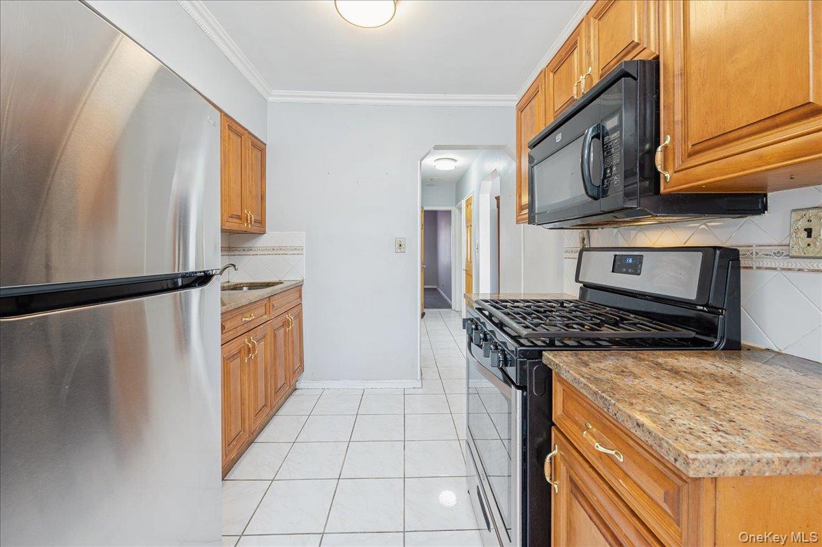412 Calhoun Avenue Bronx, NY 10465 - Photo 8 of 26 a kitchen with stainless steel appliances granite countertop a stove a sink and a refrigerator