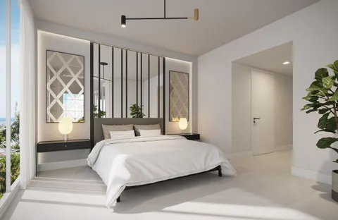 a bedroom with a large bed and a potted plant