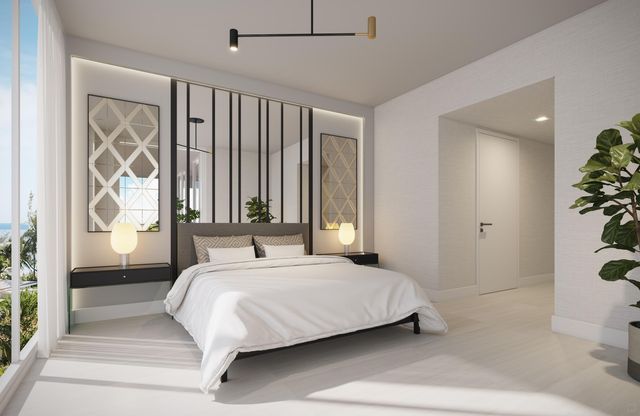 a bedroom with a large bed and a potted plant