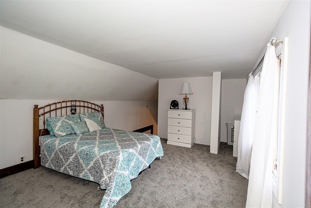 28 Flagg Road Hubbardston, MA 01452 - Photo 24 of 40 a bedroom with a bed and a refrigerator