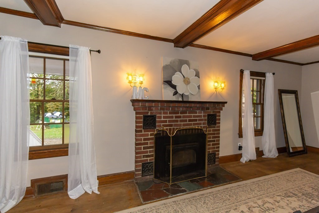 28 Flagg Road Hubbardston, MA 01452 - Photo 8 of 40 a view of a livingroom with furniture and a fireplace