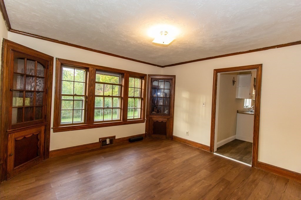 28 Flagg Road Hubbardston, MA 01452 - Photo 9 of 40 an empty room with wooden floor and windows
