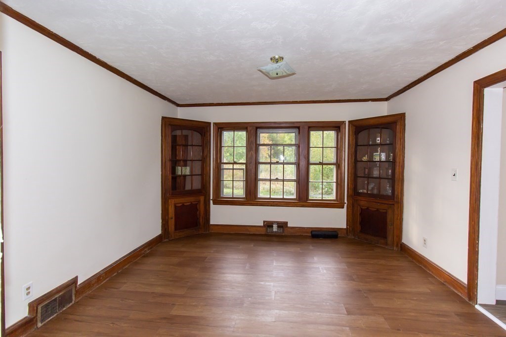 28 Flagg Road Hubbardston, MA 01452 - Photo 10 of 40 an empty room with wooden floor and windows