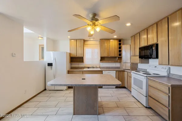 a kitchen with a refrigerator a sink and a stove