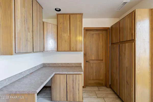 a kitchen with a sink stove top oven and cabinets