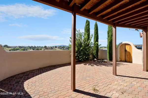 a view of a livingroom with wooden floor and bathroom
