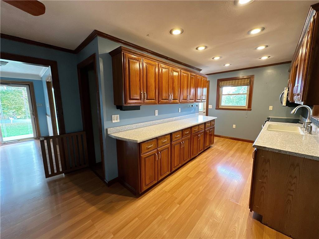 401 Clements Road Pittsburgh, PA 15239 - Photo 12 of 24 a kitchen with a wooden floor and a sink