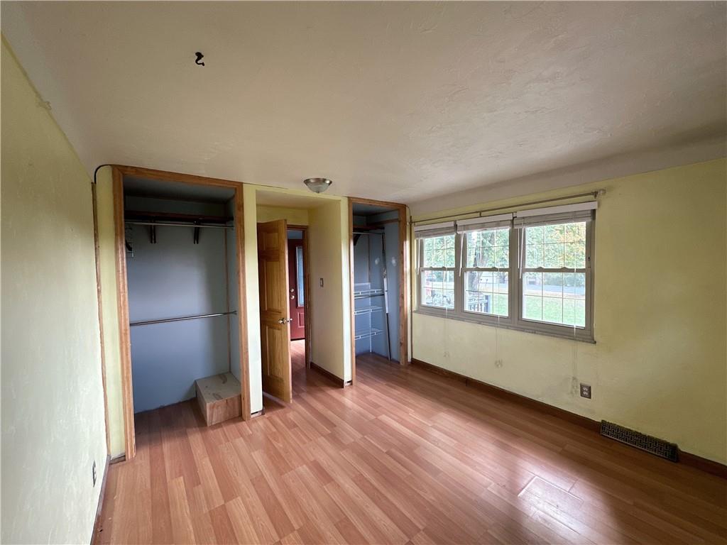 401 Clements Road Pittsburgh, PA 15239 - Photo 13 of 24 an empty room with wooden floor and windows