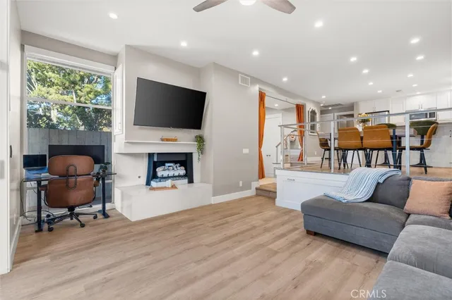 a living room with furniture fireplace and flat screen tv
