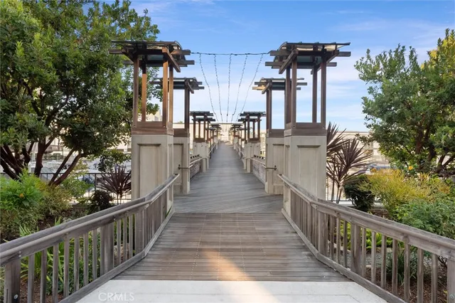 a view of a house with large trees and stairs