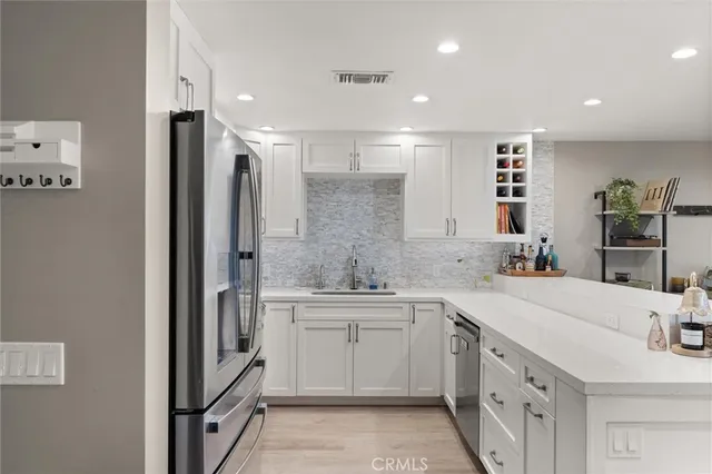 a kitchen with a sink and refrigerator
