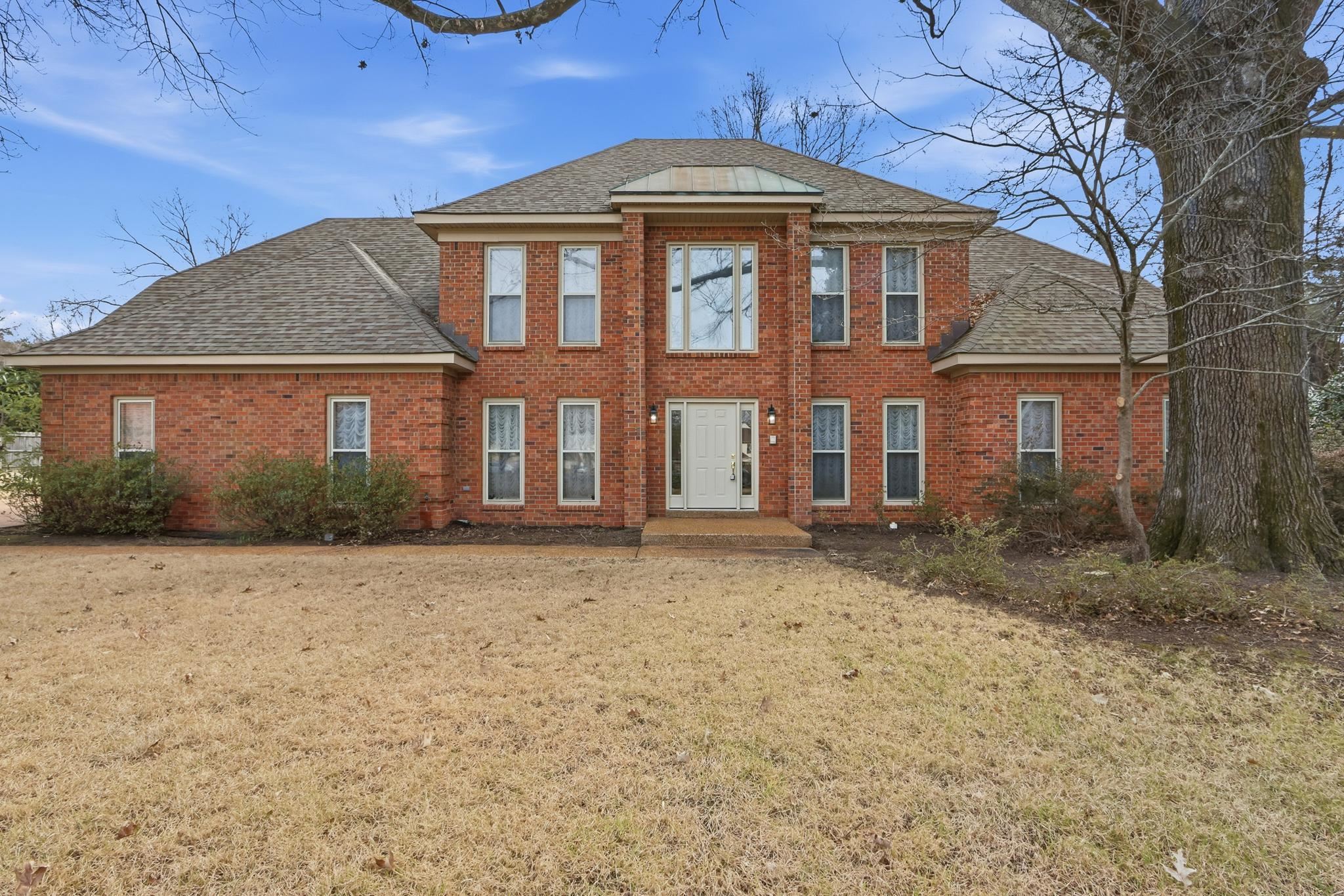 a front view of a house with a yard