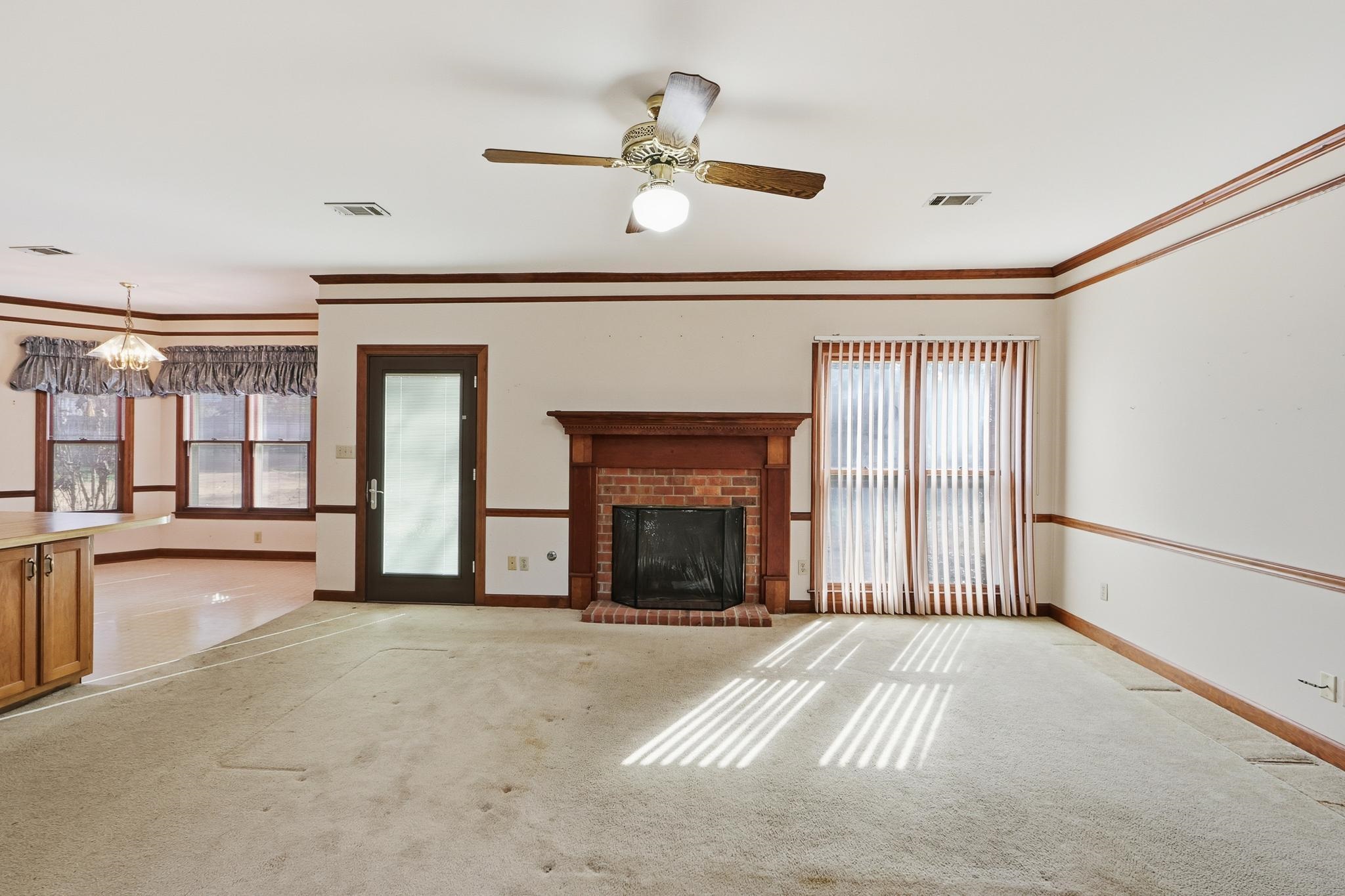 2670 Stout Rd Cove Memphis, TN 38119 - Photo 11 of 37 a view of an empty room with a fireplace and a window