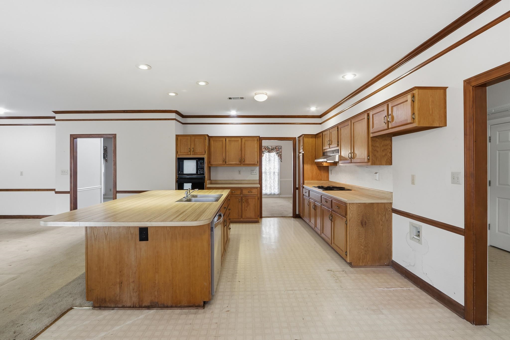 2670 Stout Rd Cove Memphis, TN 38119 - Photo 13 of 37 a kitchen with stainless steel appliances granite countertop a sink and cabinets