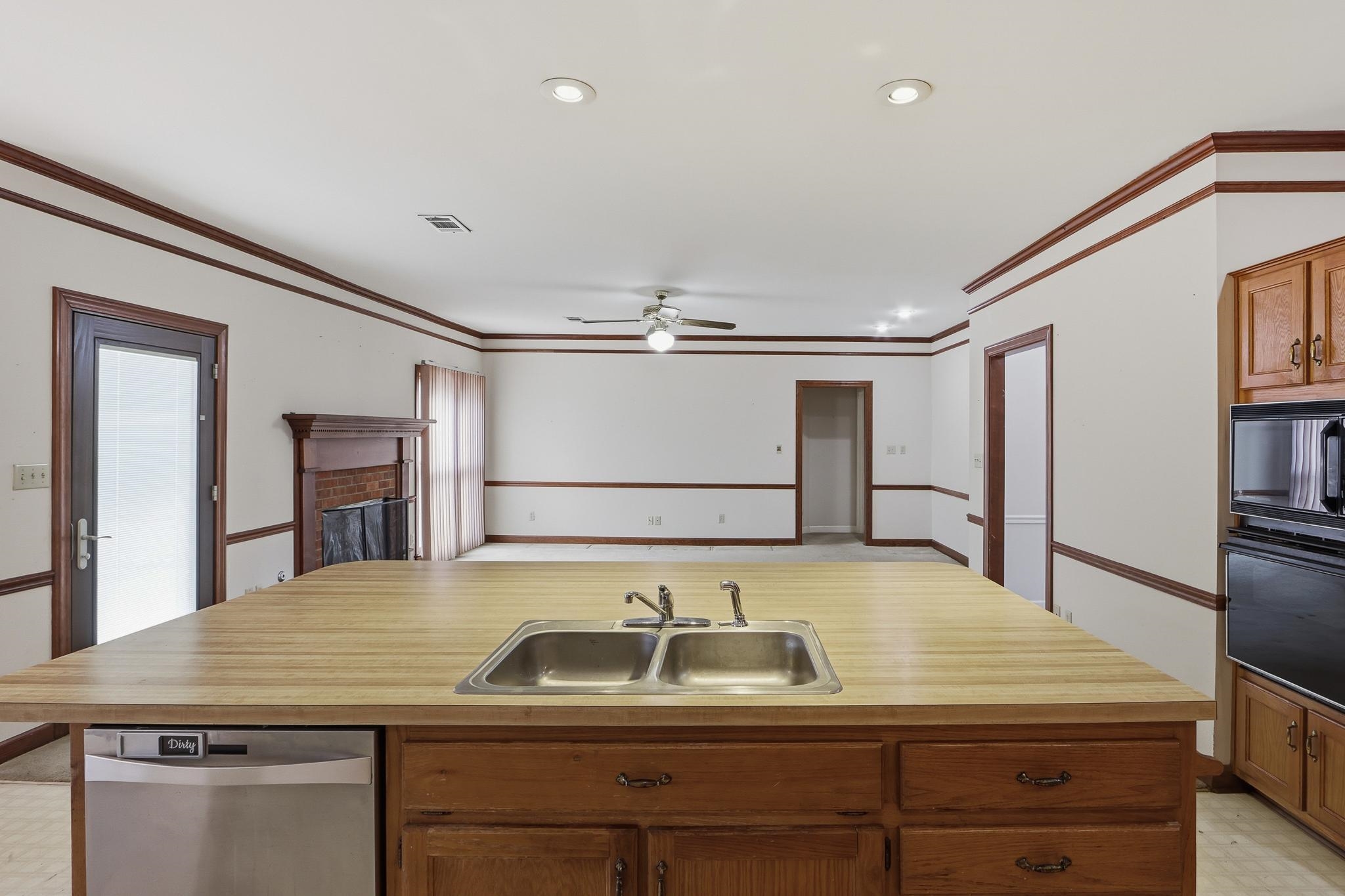 2670 Stout Rd Cove Memphis, TN 38119 - Photo 14 of 37 Kitchen featuring brown cabinets, black appliances, crown molding, light countertops, and recessed lighting