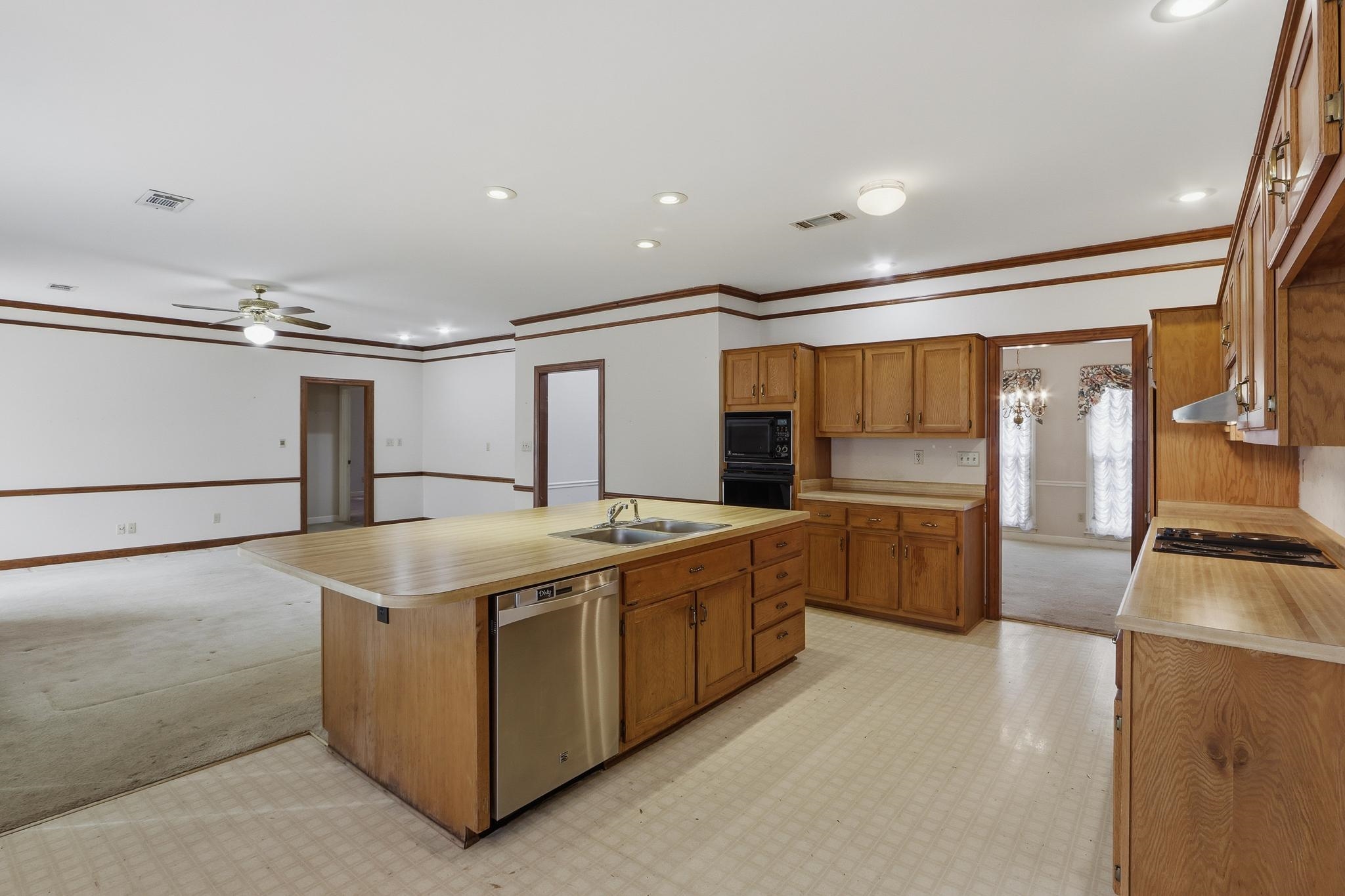 2670 Stout Rd Cove Memphis, TN 38119 - Photo 15 of 37 a kitchen with stainless steel appliances granite countertop a sink and a refrigerator