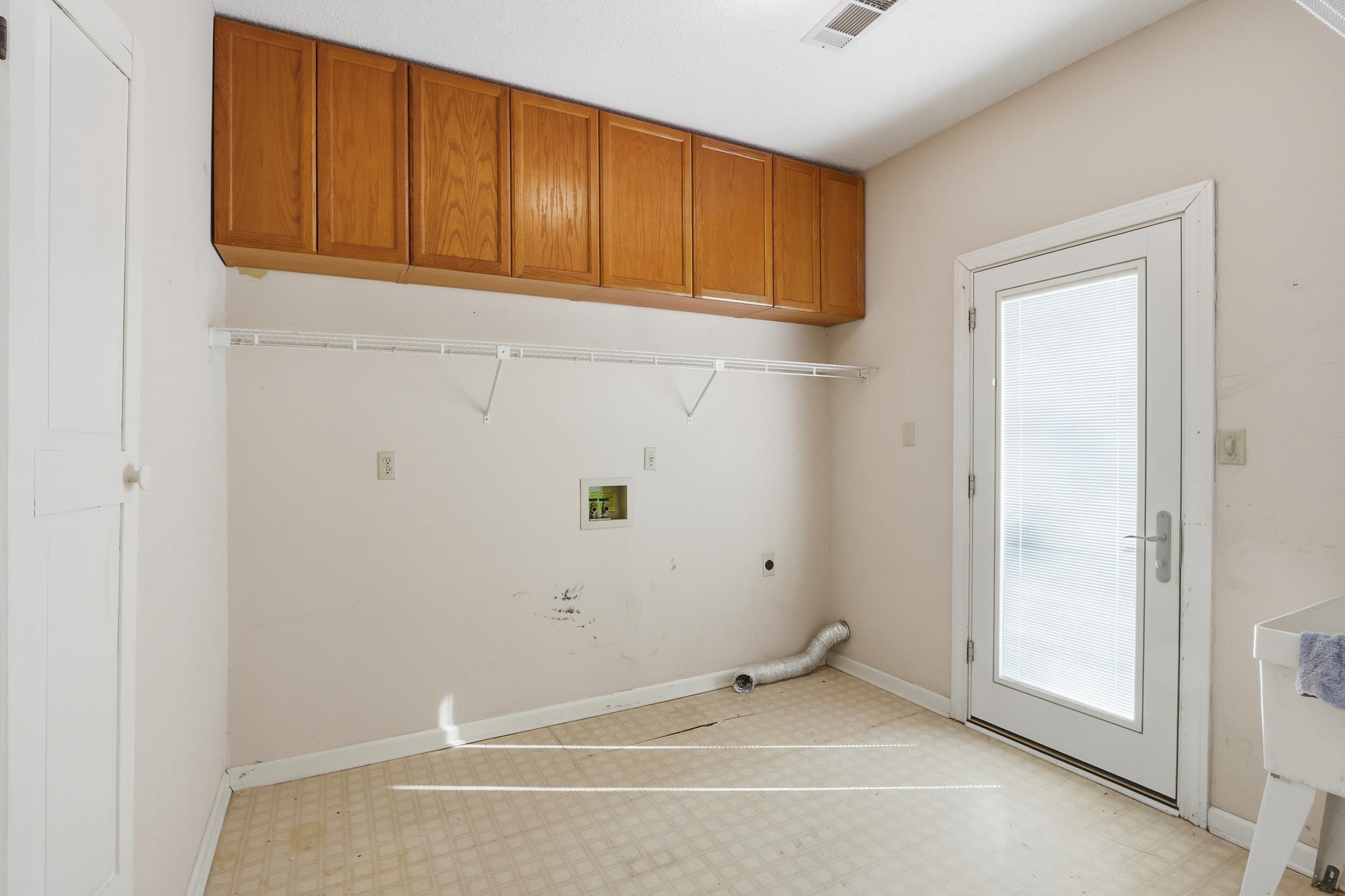 2670 Stout Rd Cove Memphis, TN 38119 - Photo 17 of 37 Washroom featuring tile patterned floors, washer hookup, and hookup for an electric dryer