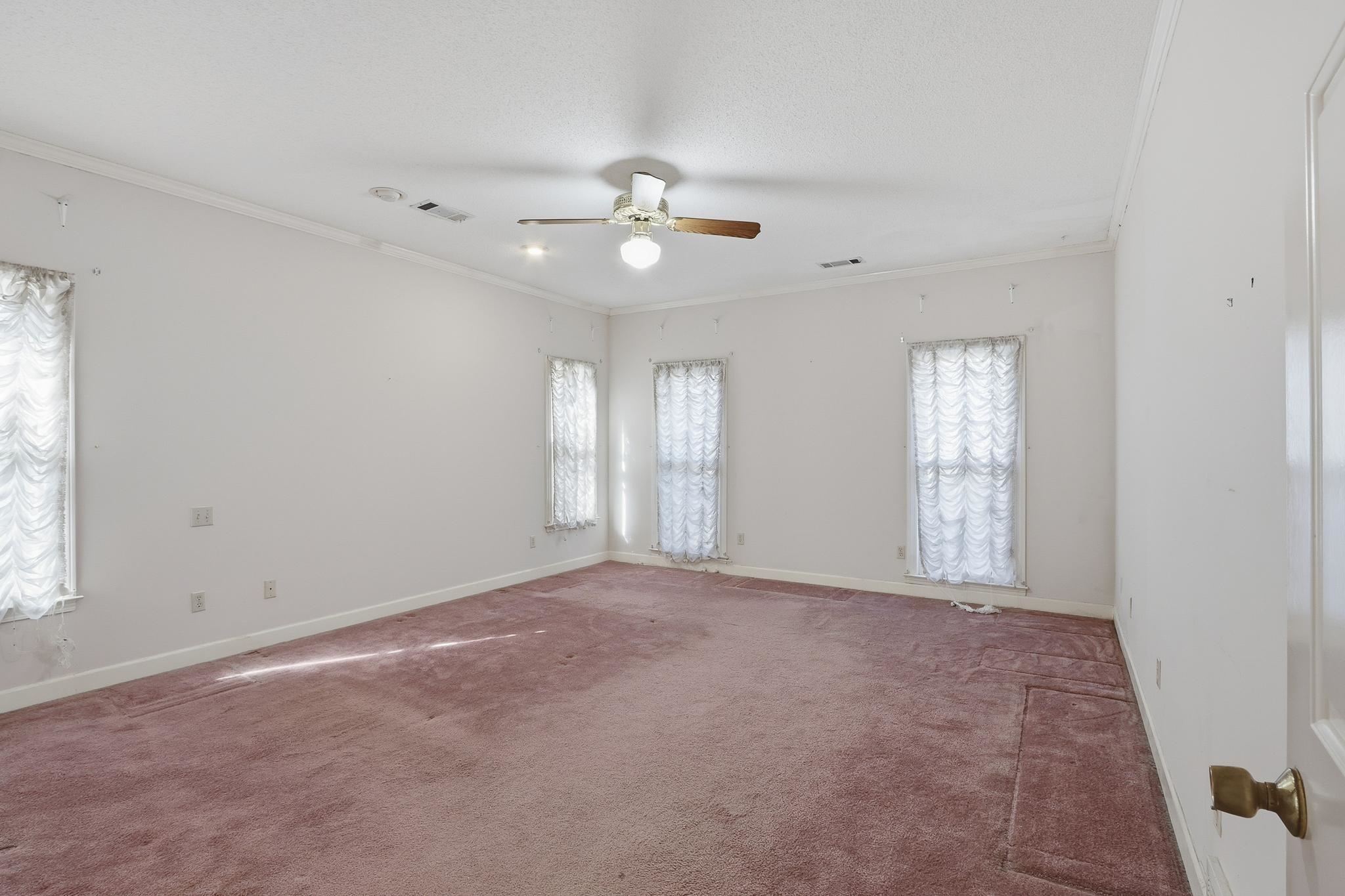 2670 Stout Rd Cove Memphis, TN 38119 - Photo 20 of 37 Empty room featuring crown molding, carpet floors, and a ceiling fan