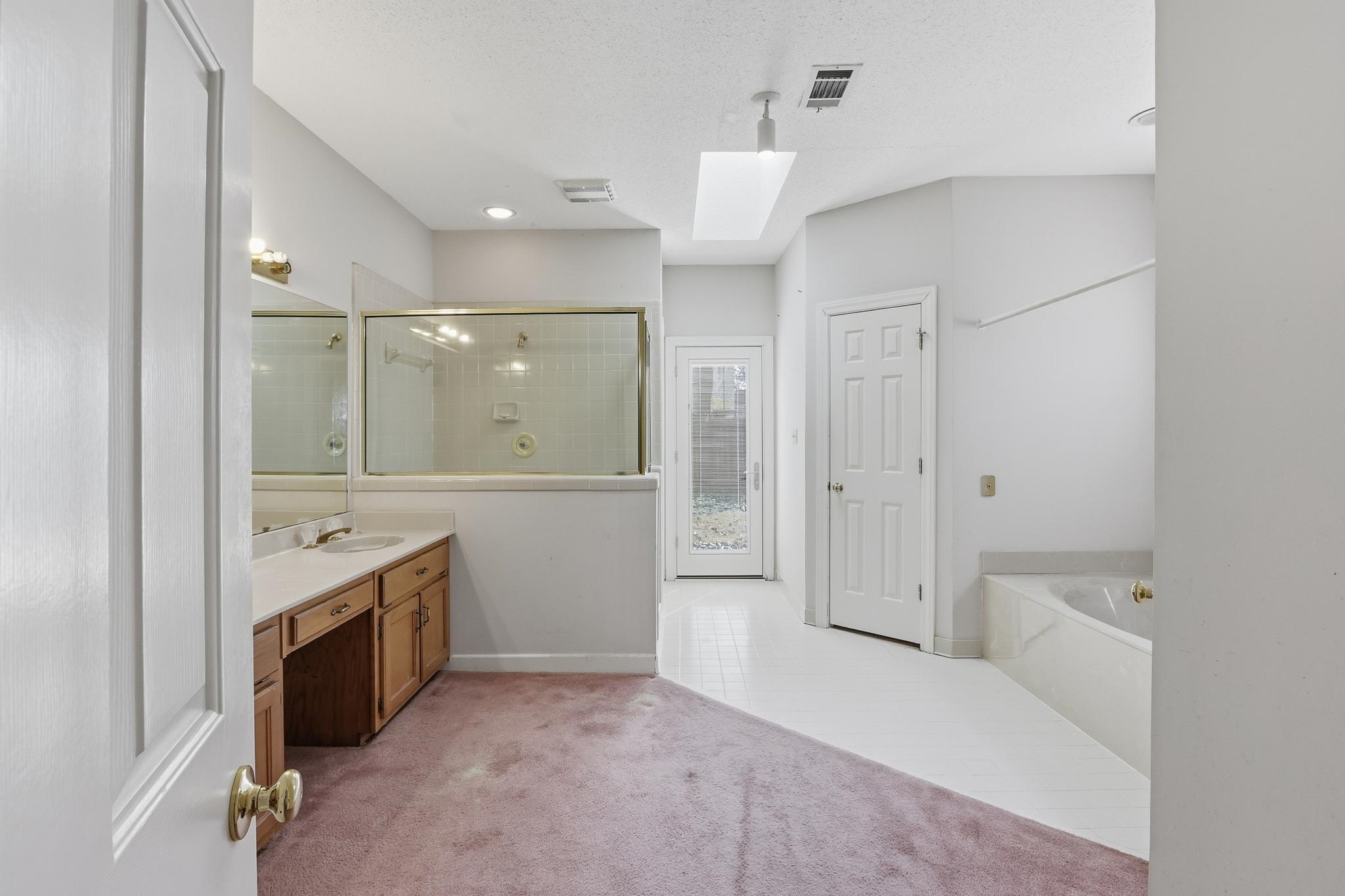 2670 Stout Rd Cove Memphis, TN 38119 - Photo 21 of 37 Full bath featuring vanity, tiled shower, a bath, light tile patterned flooring, and light carpet