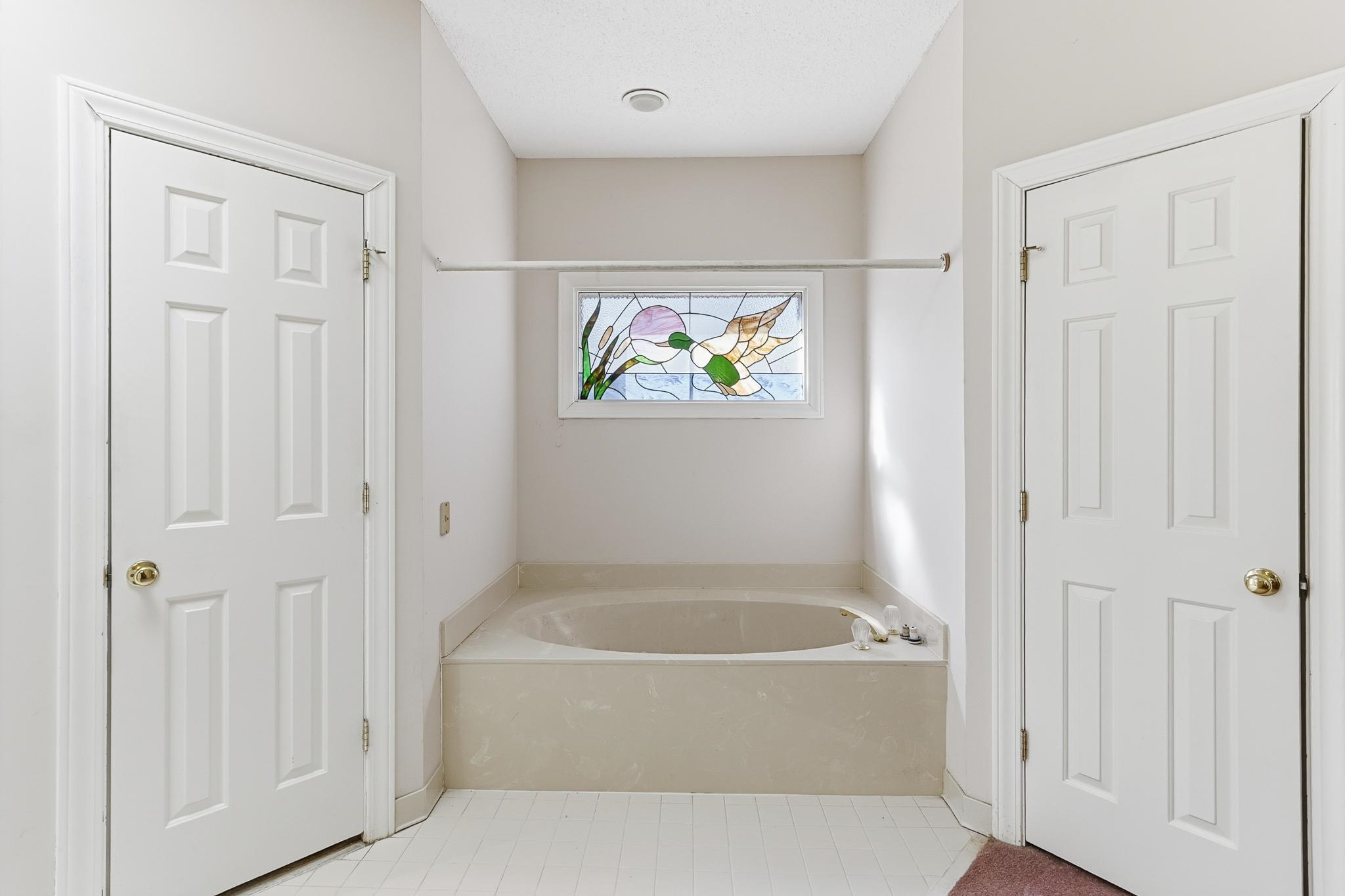 2670 Stout Rd Cove Memphis, TN 38119 - Photo 23 of 37 Bathroom featuring a garden tub and light tile patterned flooring