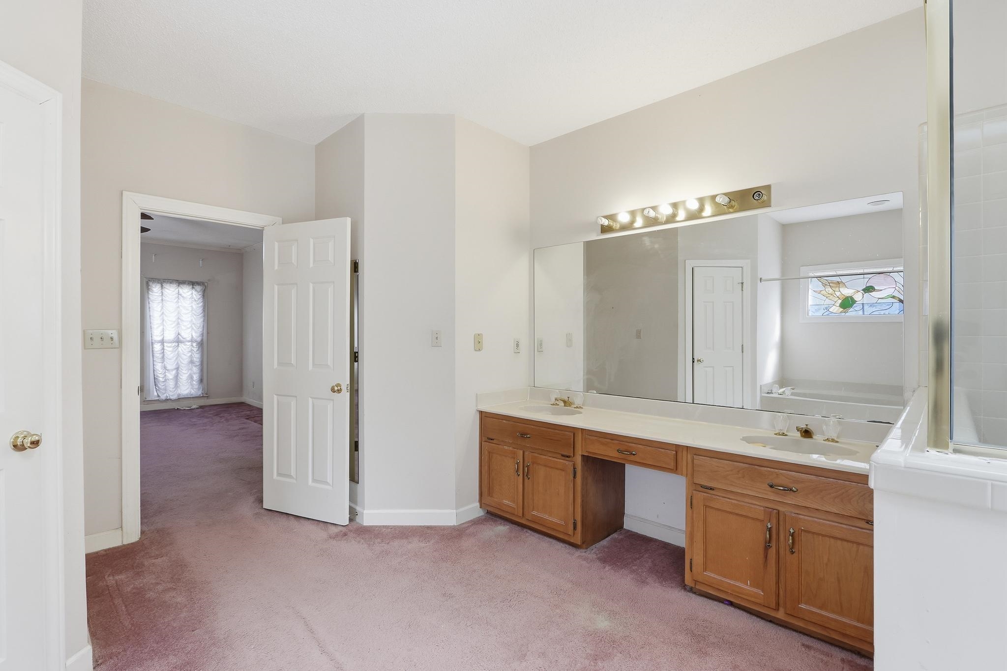 2670 Stout Rd Cove Memphis, TN 38119 - Photo 24 of 37 a spacious bathroom with a double vanity sink a large mirror and a bathtub