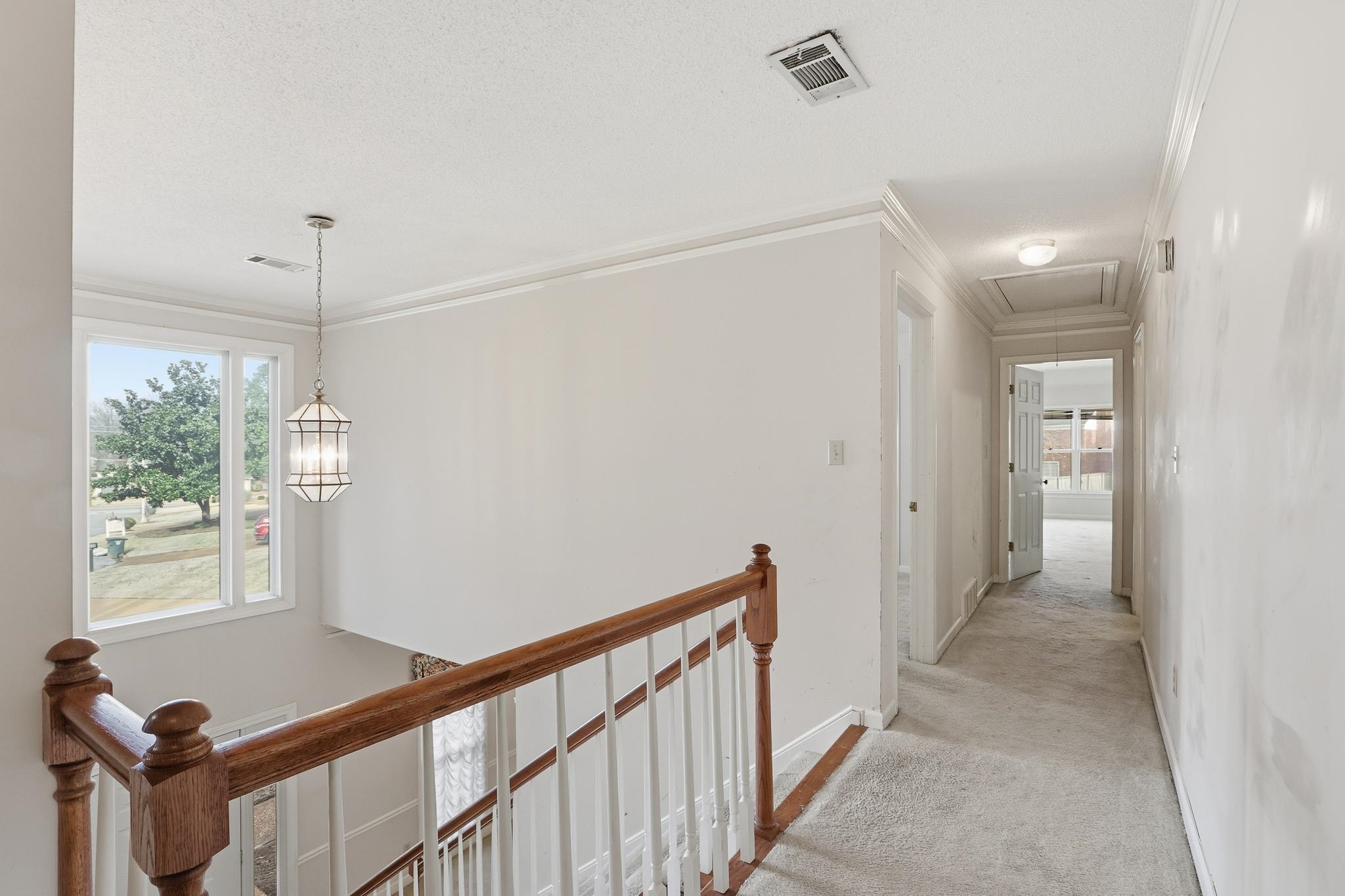 2670 Stout Rd Cove Memphis, TN 38119 - Photo 29 of 37 Hall featuring an upstairs landing, carpet flooring, crown molding, and attic access