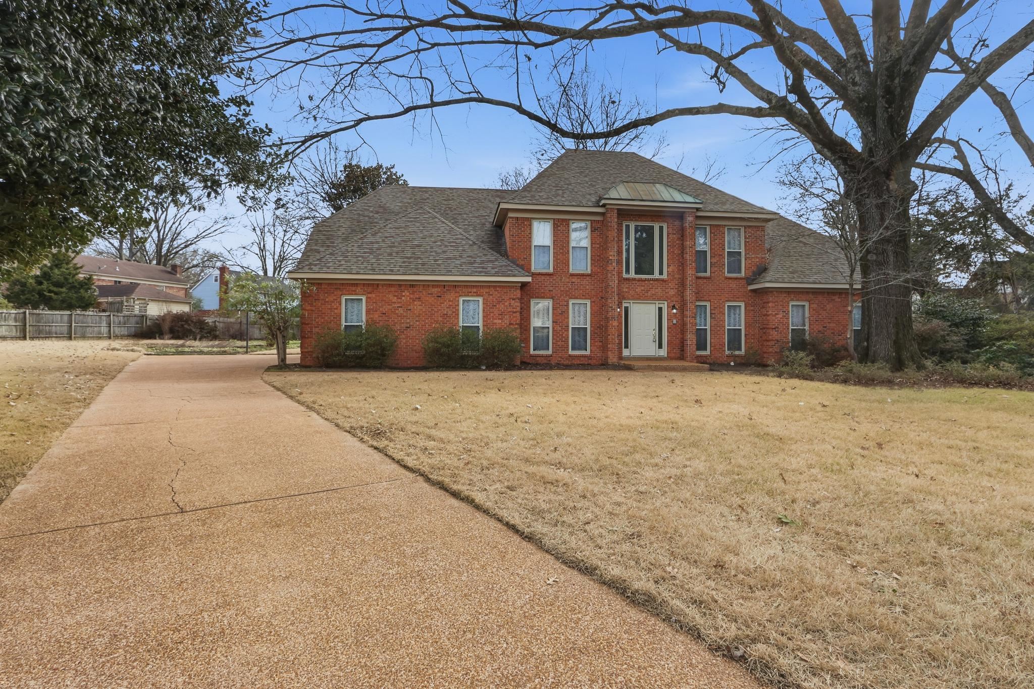 2670 Stout Rd Cove Memphis, TN 38119 - Photo 3 of 37 a front view of a house with a yard and trees
