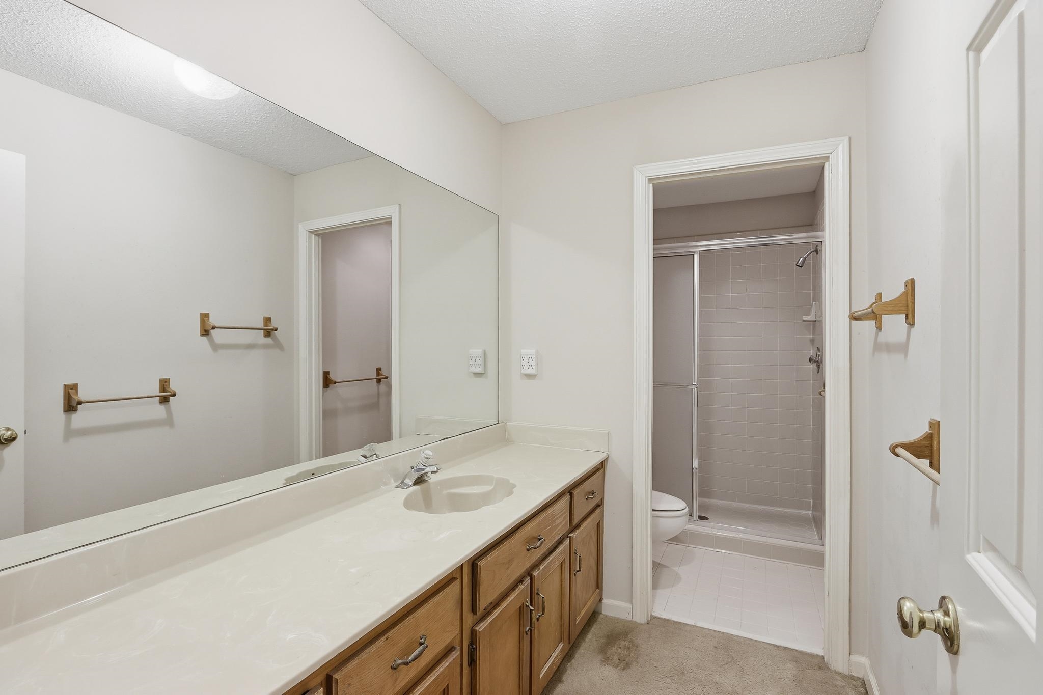 2670 Stout Rd Cove Memphis, TN 38119 - Photo 31 of 37 Full bathroom featuring a shower stall, vanity, and a textured ceiling