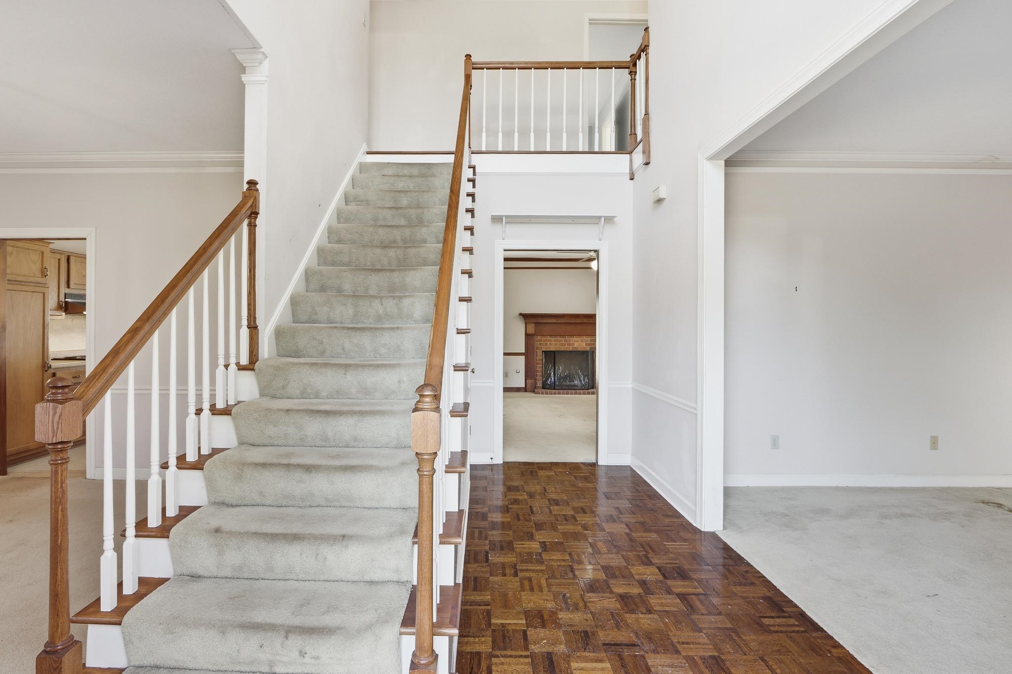 2670 Stout Rd Cove Memphis, TN 38119 - Photo 6 of 37 Stairs with carpet floors, crown molding, and a brick fireplace