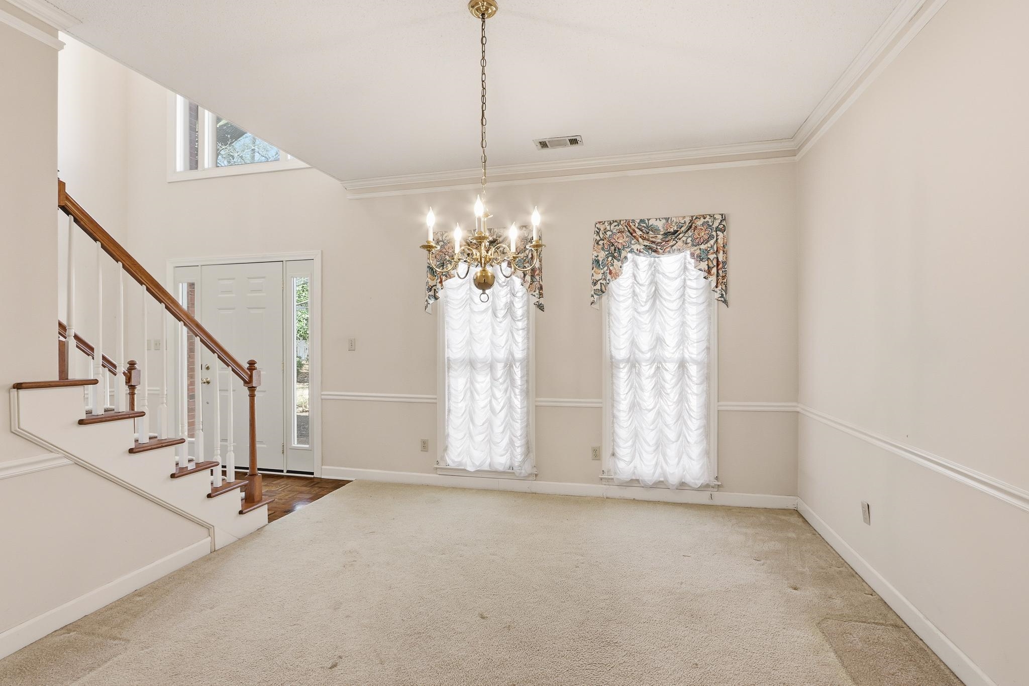 2670 Stout Rd Cove Memphis, TN 38119 - Photo 8 of 37 Entrance foyer with ornamental molding, a chandelier, stairs, and carpet