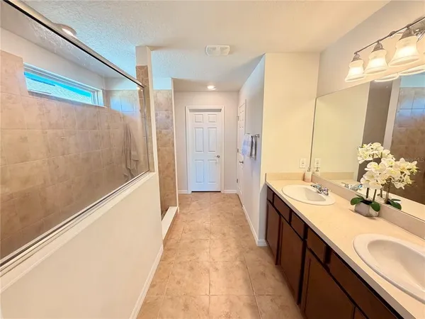 a bathroom with a sink a mirror and a shower