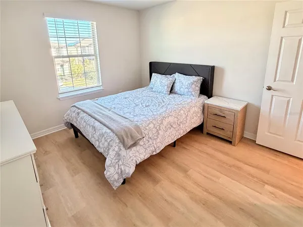 a bedroom with a bed and a window