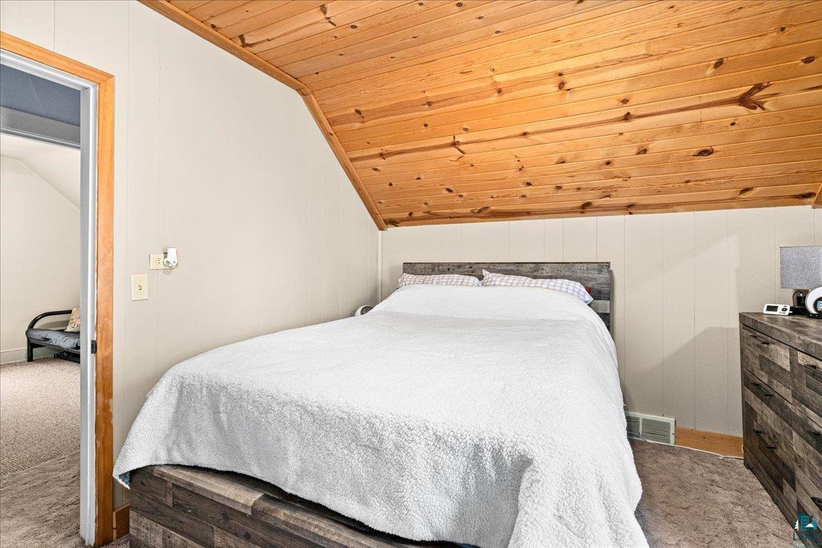 4316 West 6th Street Duluth, MN 55807 - Photo 32 of 39 Bedroom featuring carpet floors, a vaulted wood ceiling, and wood walls